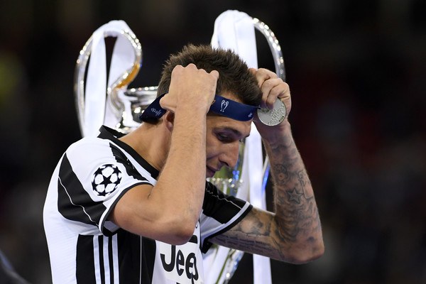 Mario Mandzukic walks by after collecting the runners-up medal 
