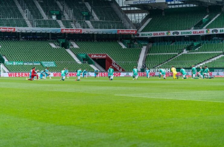 Wolfsburg players kneel down